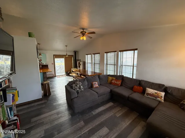 a living room with furniture a flat screen tv and a window