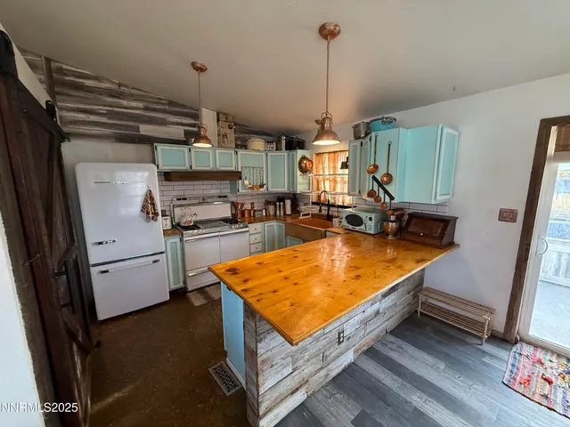 a kitchen with stainless steel appliances granite countertop a sink a stove and a refrigerator