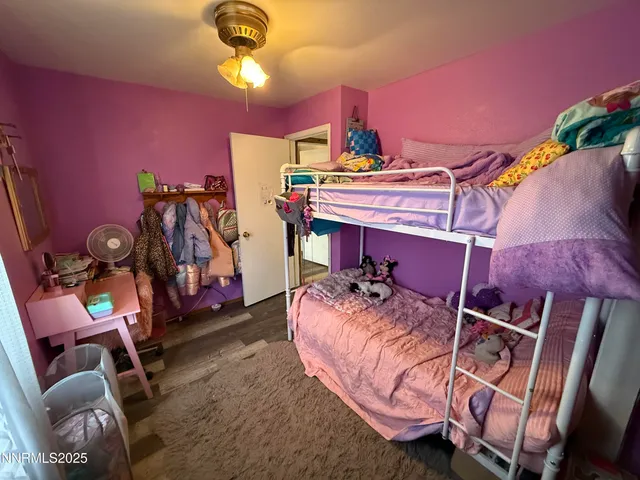 a bedroom with bed and a chandelier