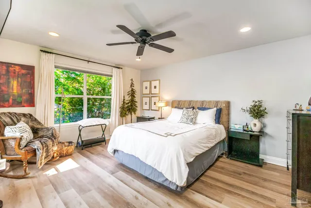 a bedroom with a bed and a large window