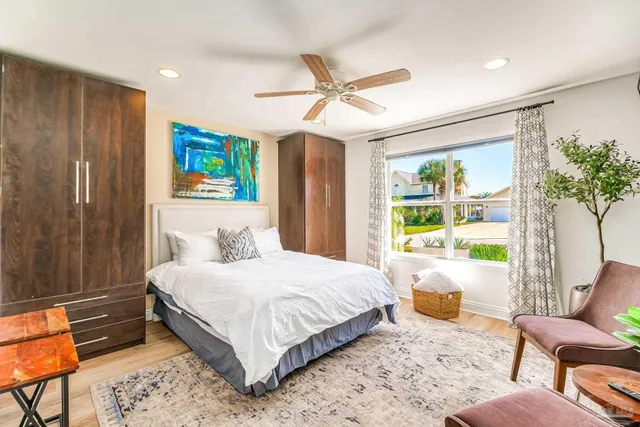 a bedroom with a bed couch and a window