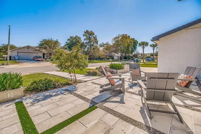 a view of a patio with furniture and a yard