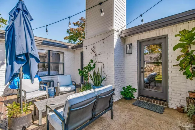 a view of backyard with outdoor seating and plants
