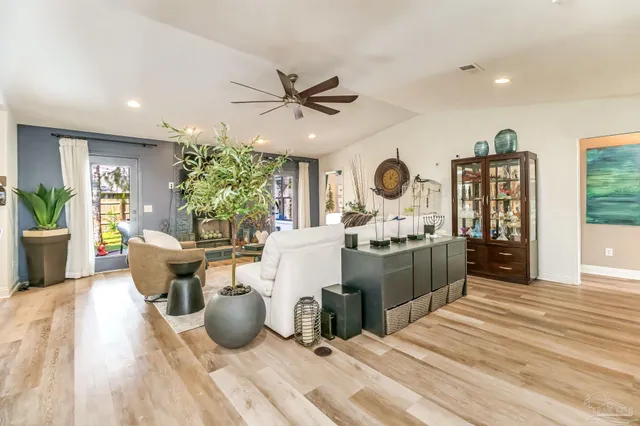 a kitchen center with white cabinets and appliances