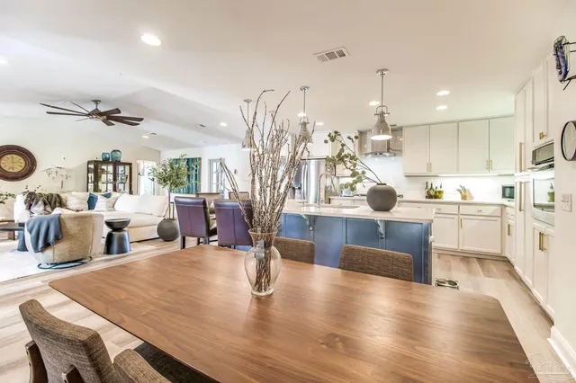 a large kitchen with a table and chairs