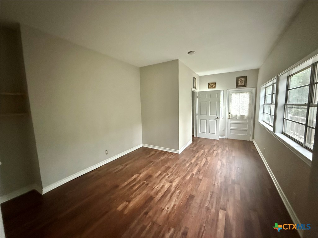 203 South 27th Street Temple, TX 76504 - Photo 12 of 15 an empty room with wooden floor and windows