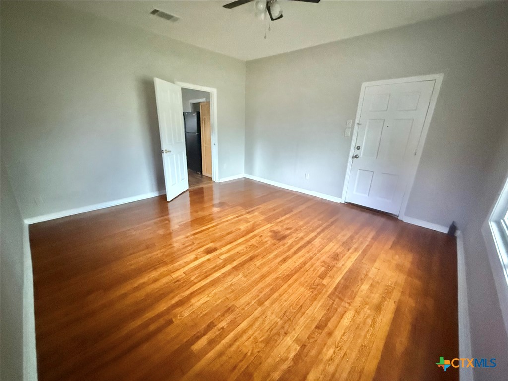 203 South 27th Street Temple, TX 76504 - Photo 4 of 15 a view of an empty room with wooden floor and a window