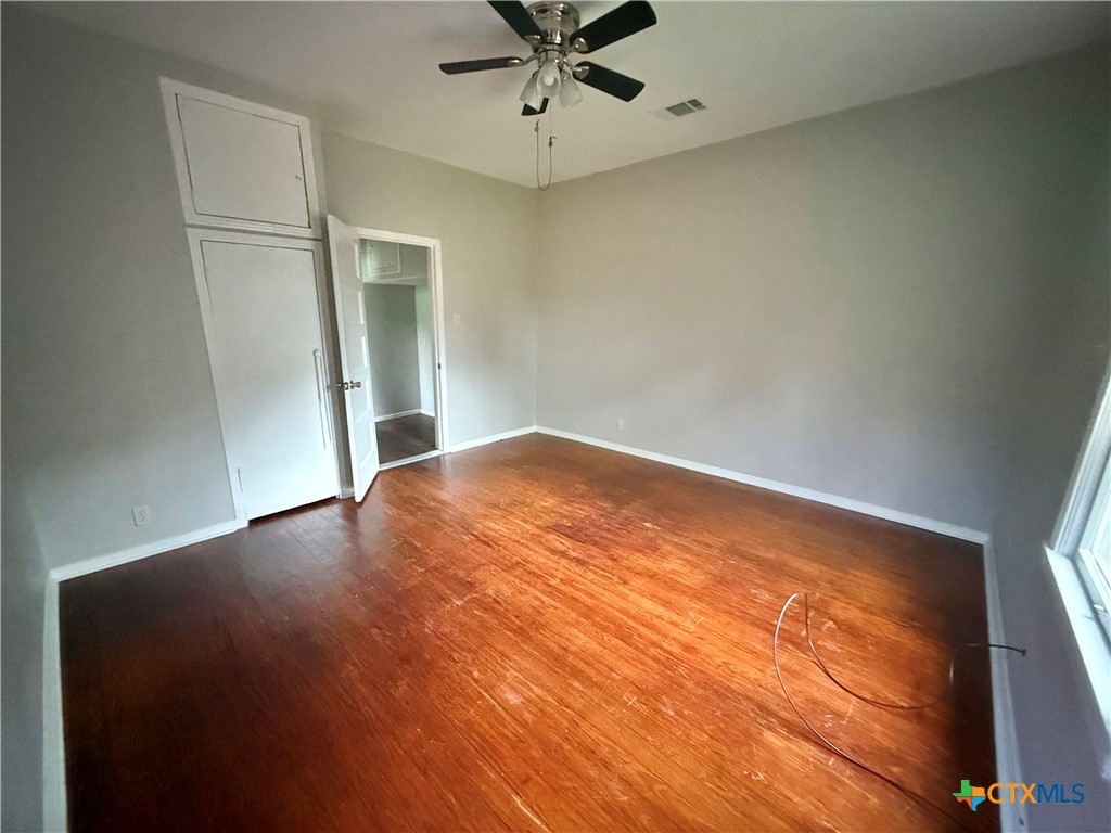 203 South 27th Street Temple, TX 76504 - Photo 10 of 15 an empty room with window and ceiling fan