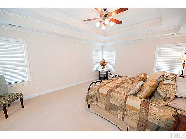208 Okamato Street Raleigh, NC 27603 - Photo 12 of 25 Master bedroom has double tray ceiling with fan and crown molding.