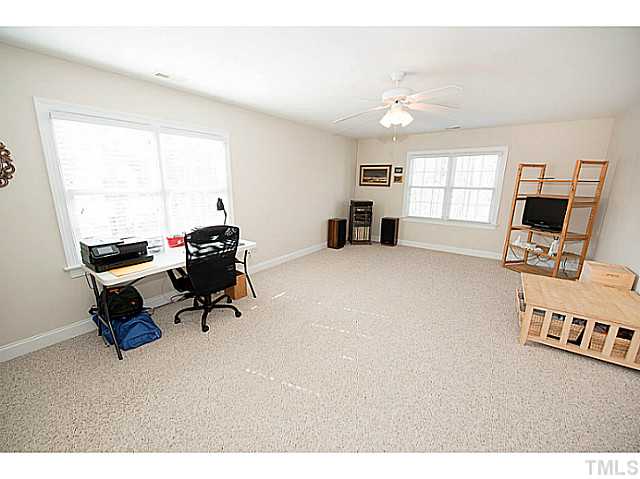 208 Okamato Street Raleigh, NC 27603 - Photo 15 of 25 Bonus room with ceiling fan and door to walk-in attic.
