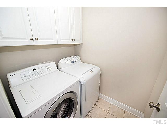 208 Okamato Street Raleigh, NC 27603 - Photo 17 of 25 Laundry room with cabinets and tile flooring.