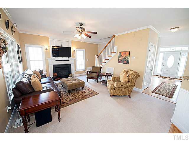 208 Okamato Street Raleigh, NC 27603 - Photo 6 of 25 Family room with gas fireplace, prewired surround sound, ceiling fan and crown molding.