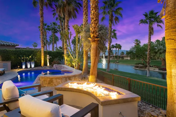 a view of a swimming pool with outdoor seating