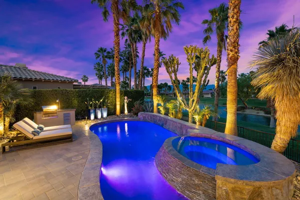 a view of a swimming pool with sitting area