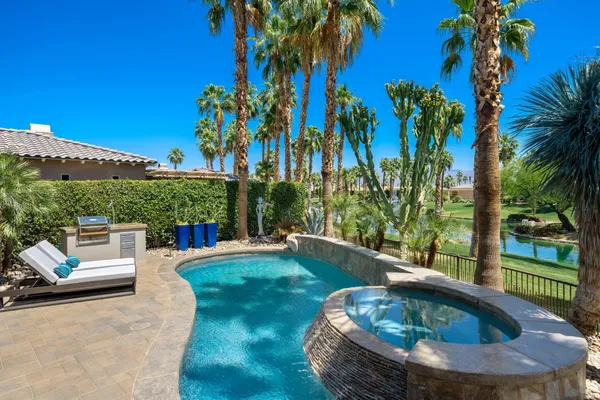 a view of a swimming pool with a patio and a garden
