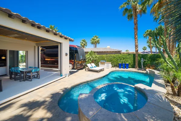 a view of a house with swimming pool and sitting area