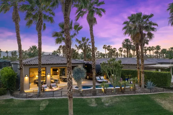 a view of a house with a swimming pool and garden