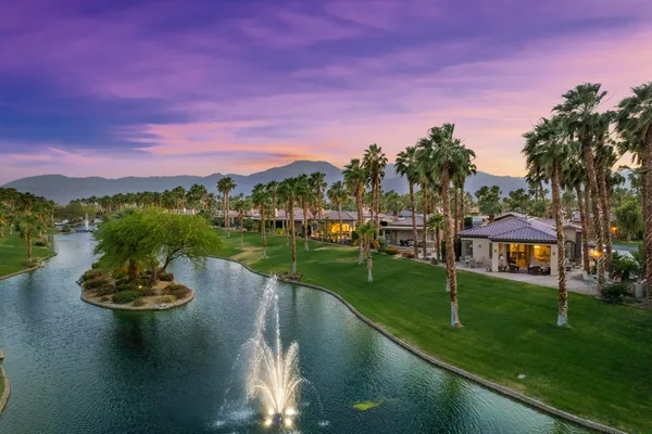a view of a lake with a house in the background