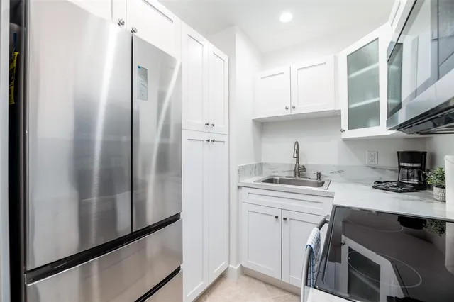 a kitchen with stainless steel appliances a sink stove and refrigerator