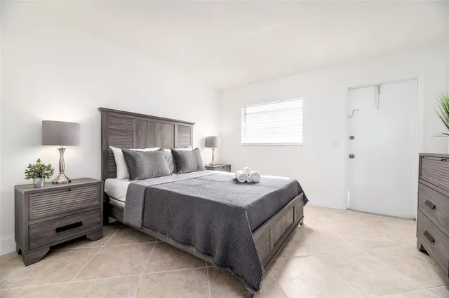 a bedroom with a bed and a night stand