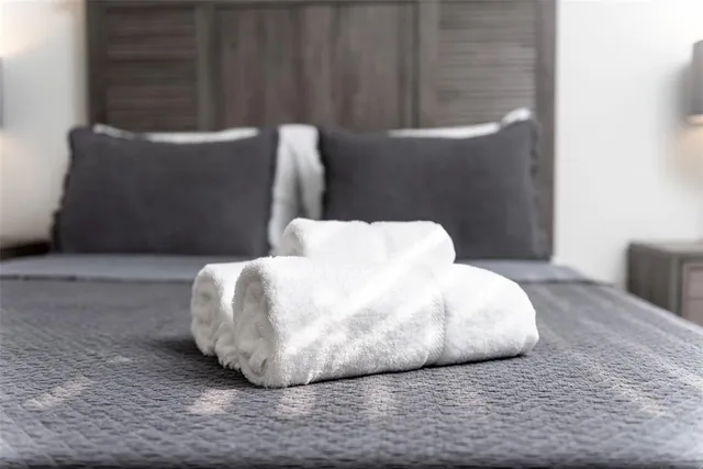 a large bed sitting in a bedroom next to a small yard