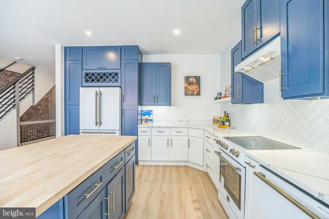 a kitchen with a sink a stove and cabinets