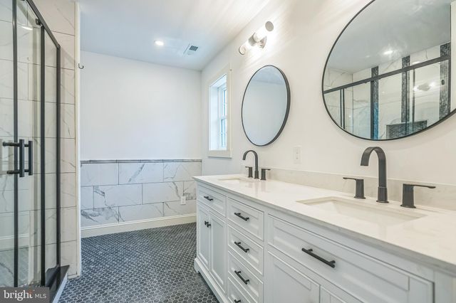 a bathroom with a shower and a glass door