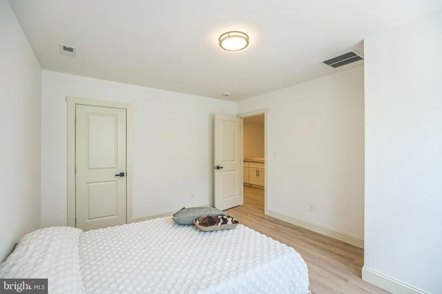a bathroom with a sink a toilet and a large mirror
