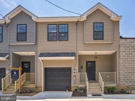 a front view of a house with garage