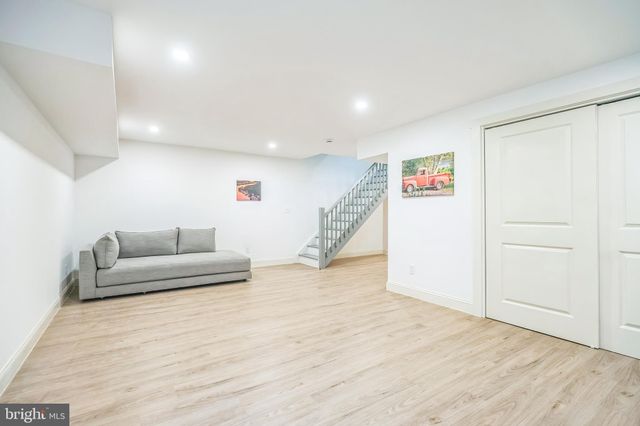 a white toilet sitting next to a white sink