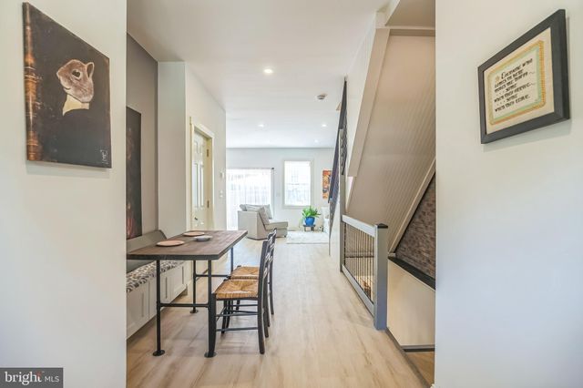 a view of a hallway with chairs and furniture