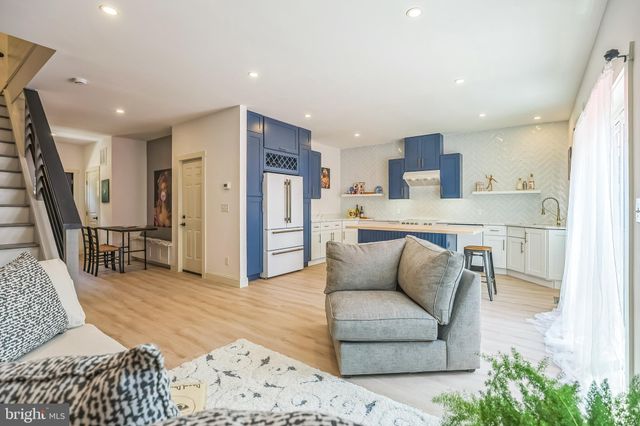 a living room with furniture and kitchen view