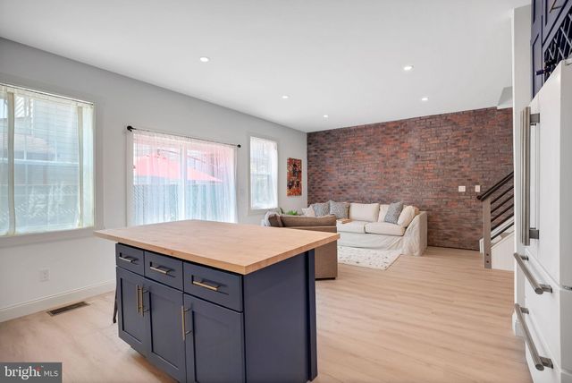 a room with a sink cabinets and wooden floor