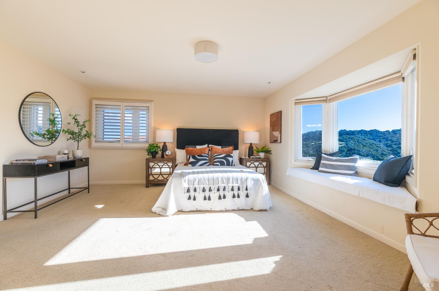 4 Galway Lane San Rafael, CA 94903 - Photo 16 of 45 a spacious bedroom with a bed a mirror and a large window