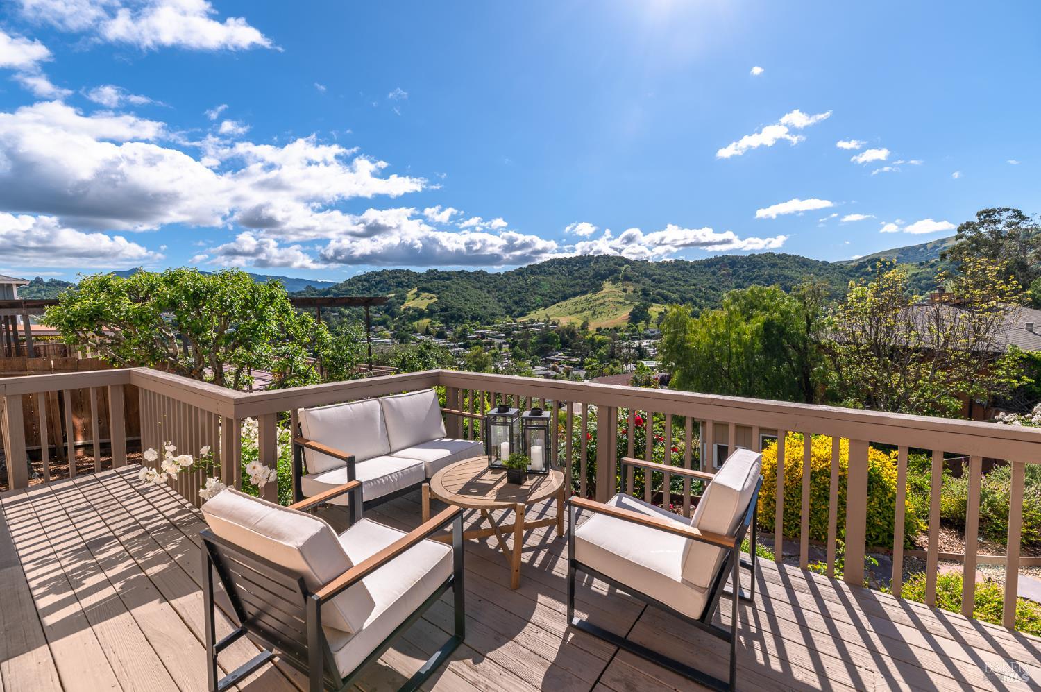 4 Galway Lane San Rafael, CA 94903 - Photo 27 of 45 a view of a balcony with wooden chairs and a floor to ceiling window
