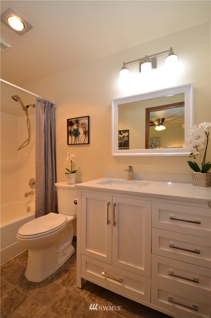 313 166th Place Southeast Bothell, WA 98012 - Photo 22 of 40 a spacious bathroom with a toilet a sink and a large mirror