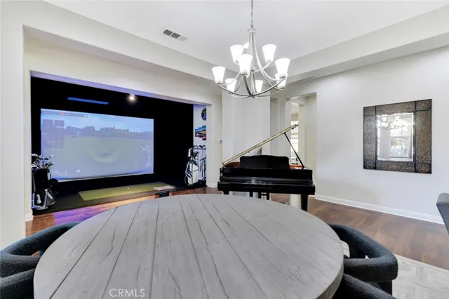a room with pool table and a chandelier