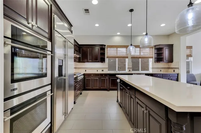 a large kitchen with stainless steel appliances