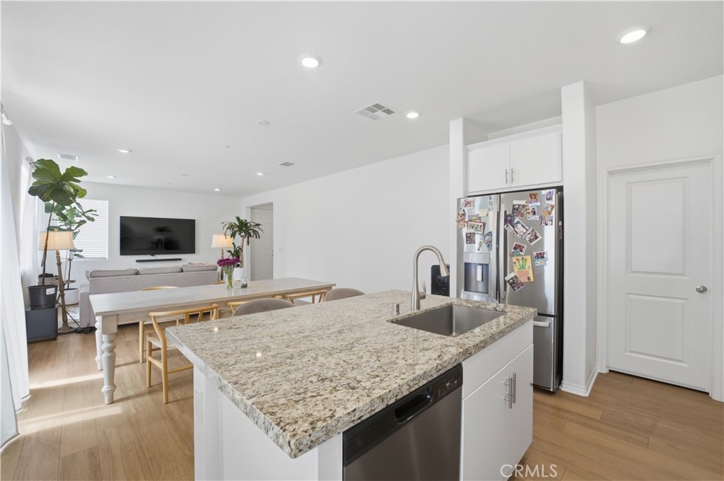 2522 Gunner Ridge Way Rialto, CA 92377 - Photo 11 of 28 a kitchen with center island and stainless steel appliances