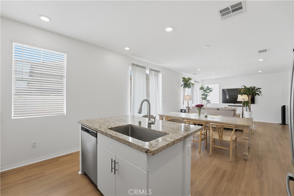 2522 Gunner Ridge Way Rialto, CA 92377 - Photo 13 of 28 a kitchen with a sink cabinets and wooden floor