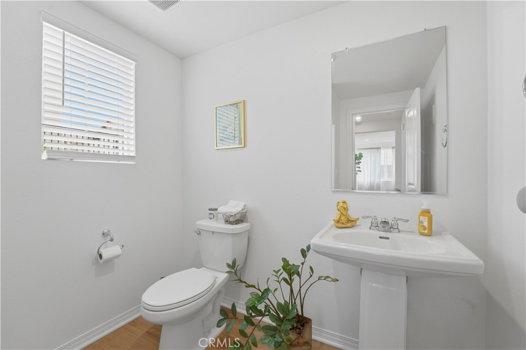 2522 Gunner Ridge Way Rialto, CA 92377 - Photo 15 of 28 a bathroom with a sink a toilet and a mirror