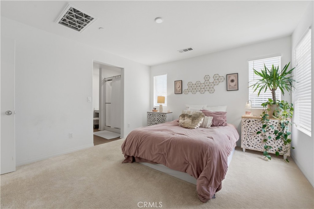 2522 Gunner Ridge Way Rialto, CA 92377 - Photo 16 of 28 a bedroom with a bed and a potted plant