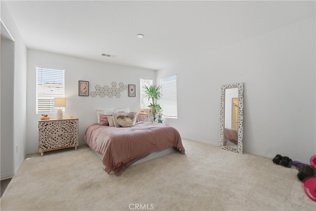2522 Gunner Ridge Way Rialto, CA 92377 - Photo 17 of 28 a spacious bedroom with a bed and a couch