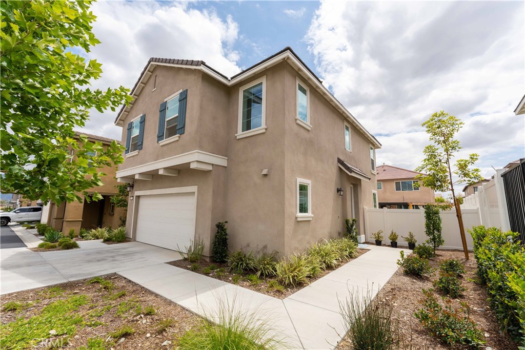 2522 Gunner Ridge Way Rialto, CA 92377 - Photo 2 of 28 a front view of a house with garden