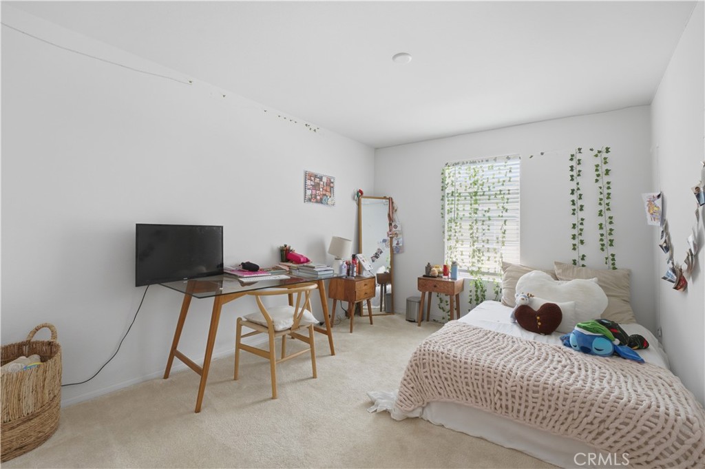 2522 Gunner Ridge Way Rialto, CA 92377 - Photo 21 of 28 a bedroom with a bed and a window
