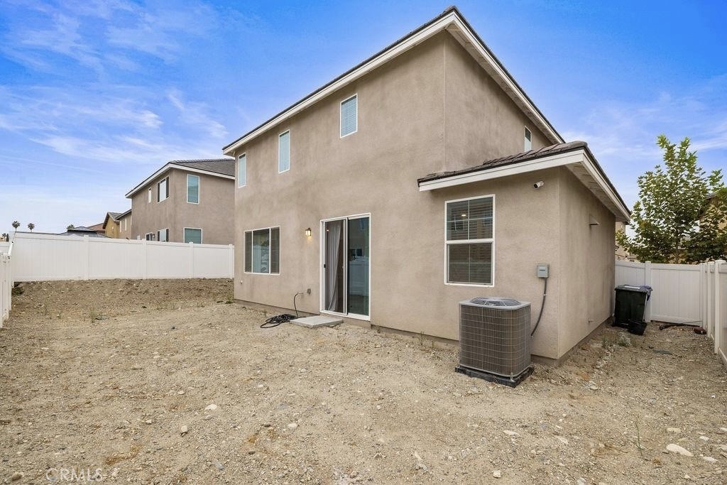 2522 Gunner Ridge Way Rialto, CA 92377 - Photo 25 of 28 a view of house with backyard and glass windows
