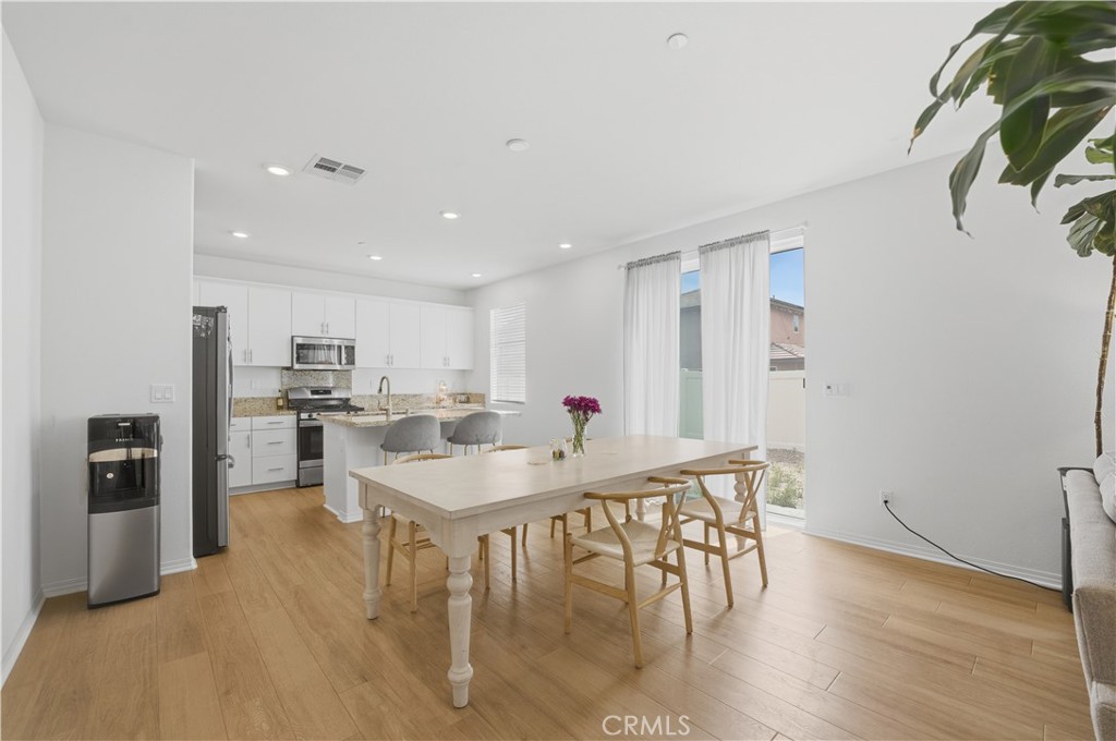 2522 Gunner Ridge Way Rialto, CA 92377 - Photo 8 of 28 a view of a dining room with furniture and wooden floor