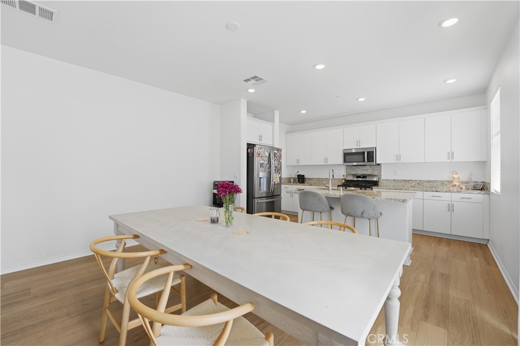 2522 Gunner Ridge Way Rialto, CA 92377 - Photo 9 of 28 a kitchen with stainless steel appliances kitchen island granite countertop a refrigerator and microwave