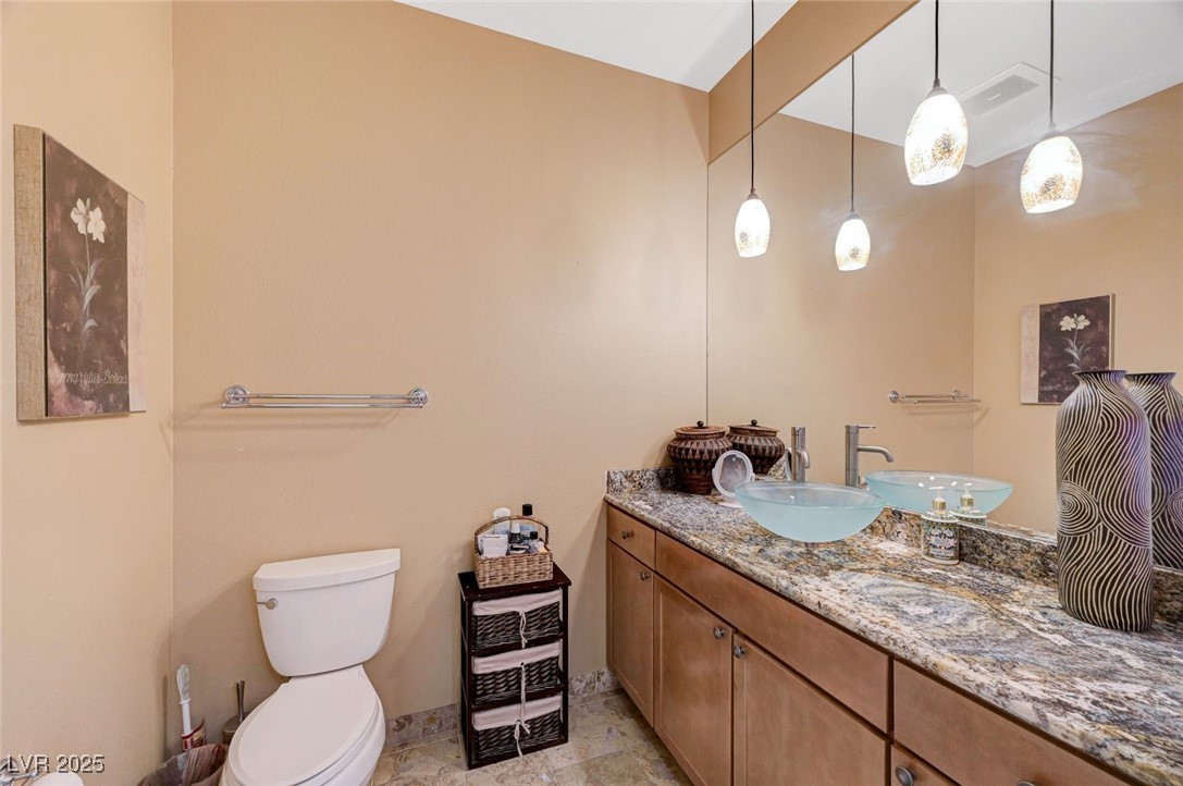 360 East Desert Inn Road, Unit 1404 Las Vegas, NV 89109 - Photo 31 of 52 Half bathroom with vanity and toilet