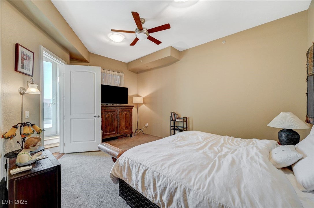 360 East Desert Inn Road, Unit 1404 Las Vegas, NV 89109 - Photo 33 of 52 Bedroom with light colored carpet and ceiling fan